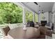 Covered porch with an outdoor fireplace, comfortable seating, and a ceiling fan for warm evenings at 420 Banbury Xing, Alpharetta, GA 30009