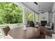 Covered porch with outdoor seating, fireplace, ceiling fan, and lush greenery at 420 Banbury Xing, Alpharetta, GA 30009