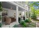 Charming outdoor porch with stone walkway, neutral furnishings, and white support columns at 420 Banbury Xing, Alpharetta, GA 30009