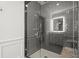 Glass-enclosed shower with subway tile and a granite bench offers a spa-like experience at home at 420 Banbury Xing, Alpharetta, GA 30009
