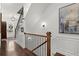 Elegant staircase with wood railing, modern lighting, and wainscoting, adding a touch of sophistication at 420 Banbury Xing, Alpharetta, GA 30009