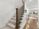Staircase with carpeted steps, a dark wood banister, and white wainscoting at 420 Banbury Xing, Alpharetta, GA 30009