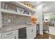 Wet bar featuring granite countertops, stainless steel appliances, and brick accents at 420 Banbury Xing, Alpharetta, GA 30009