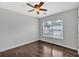 Simple bedroom with hardwood floors, a ceiling fan, and a view of the neighborhood at 535 Watercress Dr, Woodstock, GA 30188