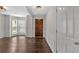 Bright foyer featuring dark hardwood floors, white trim, and a bay window in the adjacent living area at 535 Watercress Dr, Woodstock, GA 30188