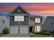 Charming two-story home featuring a combination of brick and blue siding, plus a two-car garage and manicured landscaping at 535 Watercress Dr, Woodstock, GA 30188