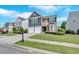 Beautiful home with a two-car garage, green lawn, and manicured shrubs at 535 Watercress Dr, Woodstock, GA 30188