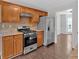 Kitchen view featuring wooden cabinets, granite countertops, and stainless steel appliances at 535 Watercress Dr, Woodstock, GA 30188