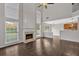 Bright living room boasts a fireplace, hardwood floors, and many windows allowing lots of natural light at 535 Watercress Dr, Woodstock, GA 30188