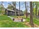 Serene backyard featuring a fire pit with built-in benches, perfect for outdoor entertaining and relaxation at 5759 Albans Way, Lithonia, GA 30058