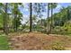 Wooded lot extends to the water's edge, offering natural privacy and a picturesque view of the calm waters at 5759 Albans Way, Lithonia, GA 30058