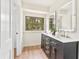 Elegant bathroom with double vanity, black cabinets, and hardwood style floor at 5759 Albans Way, Lithonia, GA 30058