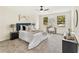 Bright bedroom features neutral decor, carpeted floor, fan, two windows, and furniture at 5759 Albans Way, Lithonia, GA 30058
