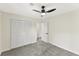 Bright bedroom features neutral decor, carpeted floor, fan, and closet at 5759 Albans Way, Lithonia, GA 30058
