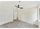 Bright bedroom features neutral decor, carpeted floor, fan, and closet at 5759 Albans Way, Lithonia, GA 30058