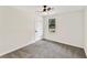 Bright bedroom features neutral decor, carpeted floor, fan, and a window at 5759 Albans Way, Lithonia, GA 30058