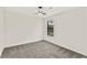 Bright bedroom features neutral decor, carpeted floor, fan, and a window at 5759 Albans Way, Lithonia, GA 30058