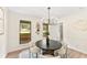 Bright dining room with modern light fixture and backyard views at 5759 Albans Way, Lithonia, GA 30058