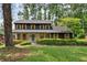 Charming two-story home with dark siding, light trim, and a landscaped front yard, creating excellent curb appeal at 5759 Albans Way, Lithonia, GA 30058