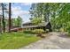 Charming two-story home with a lush front yard and inviting curb appeal, set amidst mature trees at 5759 Albans Way, Lithonia, GA 30058