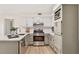 Well-lit kitchen featuring stainless appliances, a breakfast bar, and ample cabinet space, ideal for cooking and storage at 5759 Albans Way, Lithonia, GA 30058