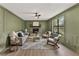 Sophisticated living room with stone fireplace and a large picture window, offering a cozy ambiance and natural light at 5759 Albans Way, Lithonia, GA 30058