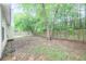 Spacious backyard featuring a wood fence and mature trees for privacy at 5779 Wellborn Creek Dr, Lithonia, GA 30058