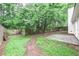 Backyard featuring a lush lawn, wood fence, a patio, and brick walkway at 5779 Wellborn Creek Dr, Lithonia, GA 30058