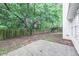 The backyard has a concrete patio, a wood fence, and mature shade trees at 5779 Wellborn Creek Dr, Lithonia, GA 30058