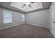 Spacious bedroom with trey ceilings, plush carpet, and natural light at 5779 Wellborn Creek Dr, Lithonia, GA 30058