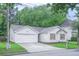 Charming single-story home features a two-car garage, lush lawn, and beautiful landscaping at 5779 Wellborn Creek Dr, Lithonia, GA 30058