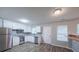 Kitchen with stainless steel appliances, modern white cabinets, and a gray backsplash at 5779 Wellborn Creek Dr, Lithonia, GA 30058