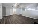 Open-concept area with dark floors and a large ceiling fan at 5779 Wellborn Creek Dr, Lithonia, GA 30058