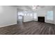 Bright living room flows to the eat-in kitchen. Features a fireplace and dark floors at 5779 Wellborn Creek Dr, Lithonia, GA 30058
