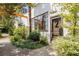 Charming building exterior featuring industrial windows, lush landscaping, and a welcoming entrance at unit number two at 820 Dekalb Ne Ave # 2, Atlanta, GA 30307
