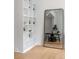 Bright living room featuring hardwood floors, large bookshelf and a mirror reflecting dining area at 820 Dekalb Ne Ave # 2, Atlanta, GA 30307