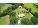Expansive property featuring a home, a guest house, and a large, well-maintained yard surrounded by trees at , Social Circle, GA 30025