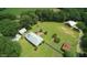 Aerial view of a ranch with manicured lawns, separate buildings, and mature trees at , Social Circle, GA 30025