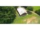 Aerial view of a large barn with a metal roof and surrounding greenery, showcasing the property's vastness at , Social Circle, GA 30025