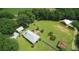 Aerial view of a charming property with multiple outbuildings, mature trees, and lush greenery at , Social Circle, GA 30025