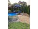 Inviting backyard featuring a stock tank pool, seating area, and lush greenery at , Social Circle, GA 30025