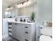 This bathroom features a gray vanity with quartz countertops, a framed mirror, and modern lighting at , Social Circle, GA 30025