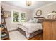 This bedroom features hardwood floors, neutral walls, a decorative ladder, and lots of natural light at , Social Circle, GA 30025