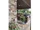 Inviting covered patio featuring stone accents, ceiling fan, stylish furniture, and beautiful outdoor decor at , Social Circle, GA 30025