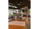 Charming covered patio with stone fireplace, TV, comfortable seating, and wood accents at , Social Circle, GA 30025