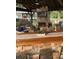 Well-designed covered patio with stone fireplace, TV, bar seating, and comfortable lounge area at , Social Circle, GA 30025