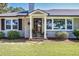 Close-up of the home's entrance, showcasing a charming porch, updated windows, and manicured landscaping at , Social Circle, GA 30025