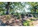 Single-story home nestled on a lush lot with mature trees, a garden, and natural landscaping at , Social Circle, GA 30025