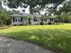 Charming single-story home with a well-maintained lawn, a stone walkway, and meticulously trimmed hedges at , Social Circle, GA 30025
