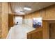 Bright garage with a large roll-up door, exposed plywood walls, and stairs to the upper level at , Social Circle, GA 30025